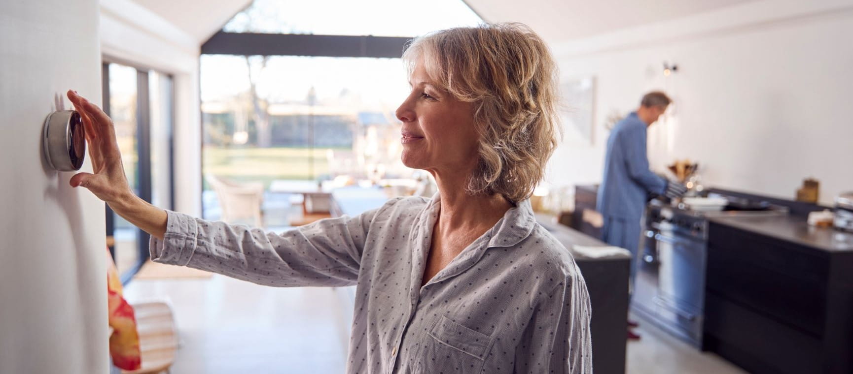 Woman fiddling with the temperature in her massive kitchen