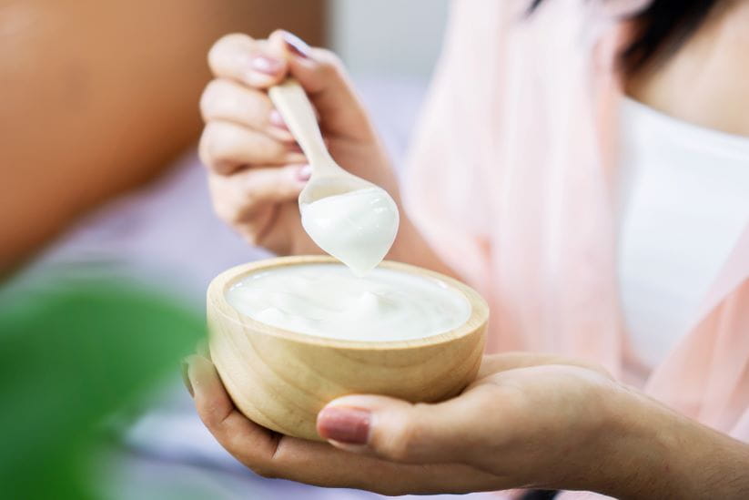 woman eating yogurt in a bowl