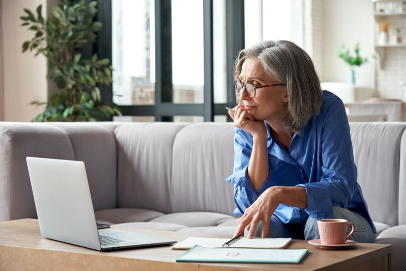 Woman looking at her laptop booking a trip