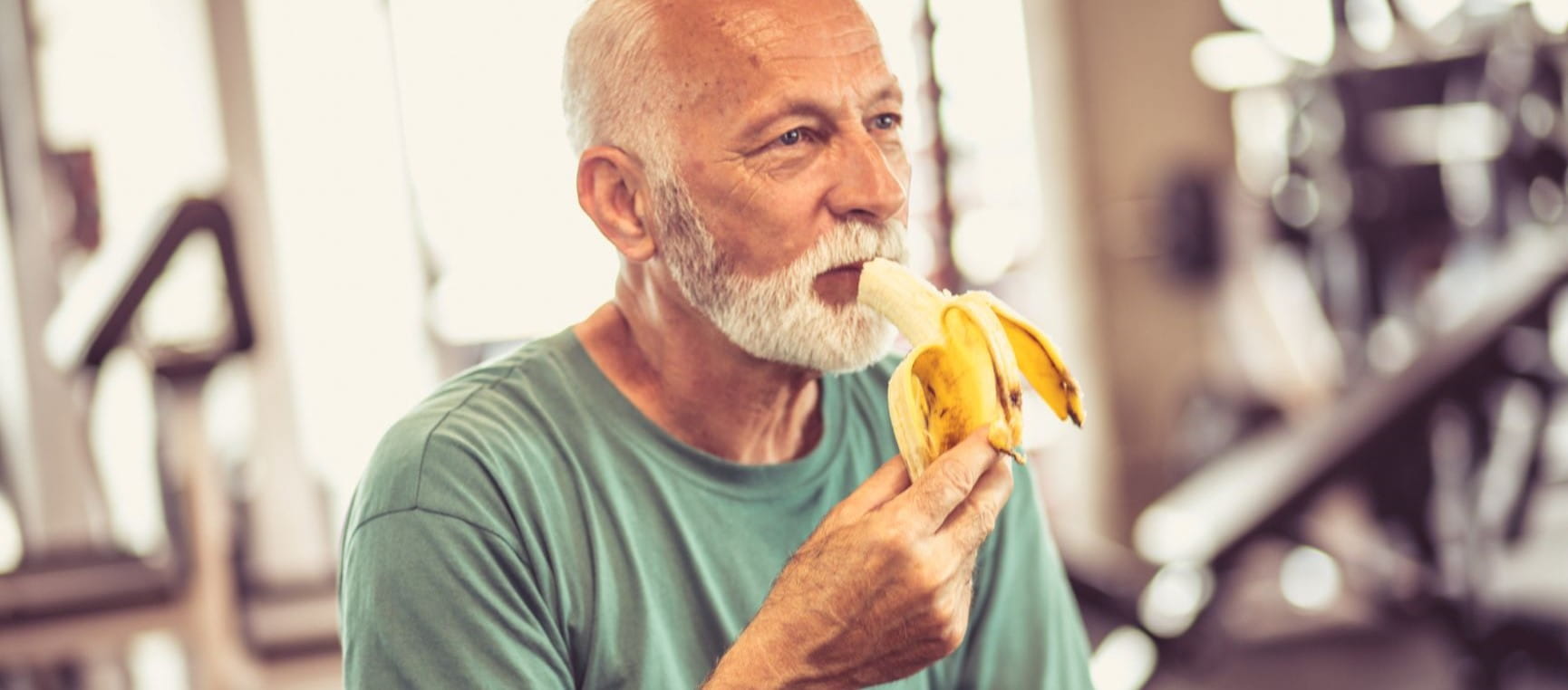 Man eating a banana at the gym