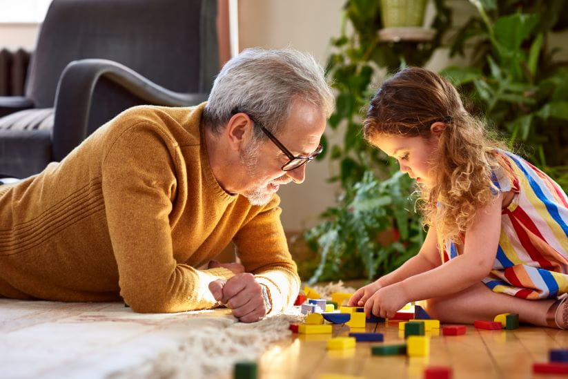 Man playing a game with his granddaughter