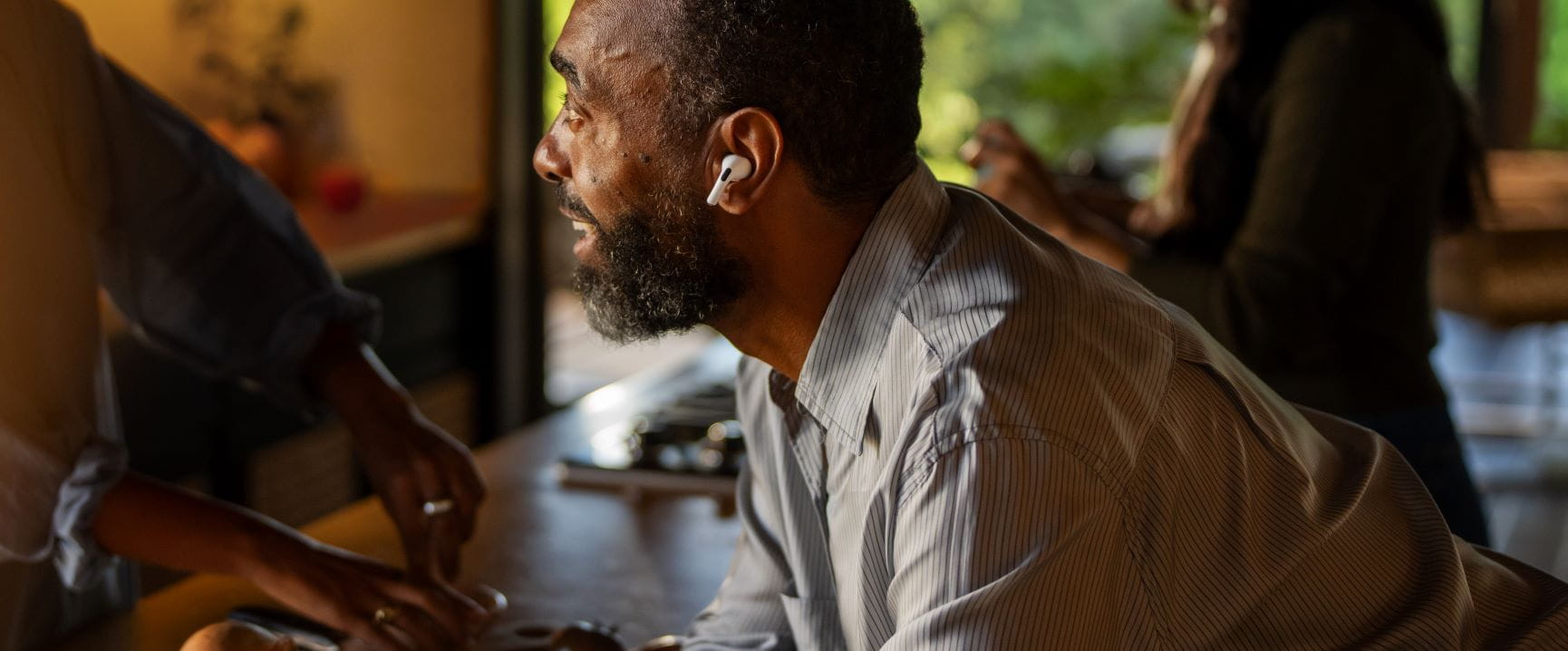 man in an exercise class with an airpod in his ear
