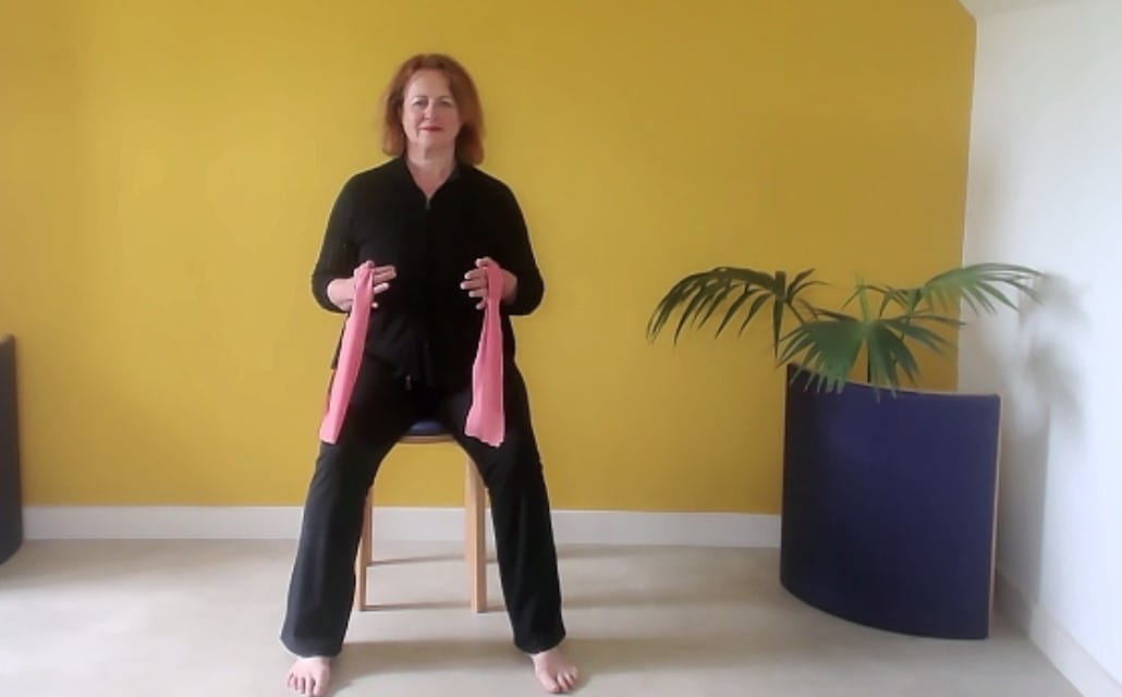 Woman sat on a chair breathing deep