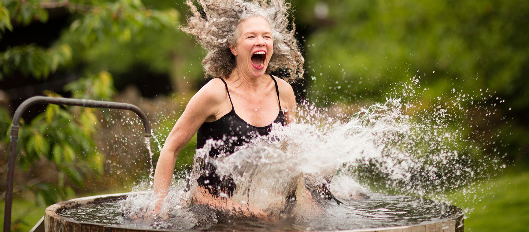 Woman getting in a cold ice bath