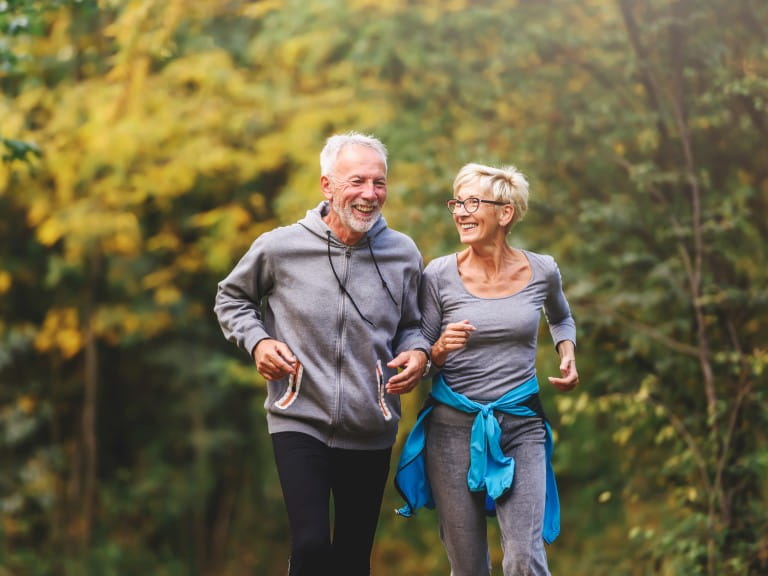An older couple run together | Getty/Lordn