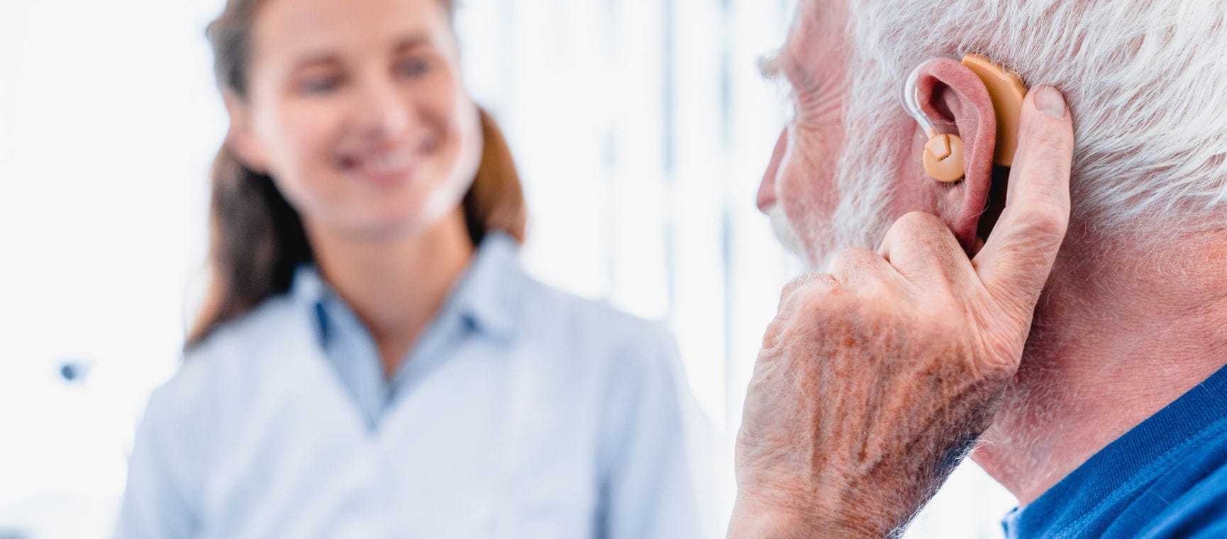 A man being fitted with a hearing aid
