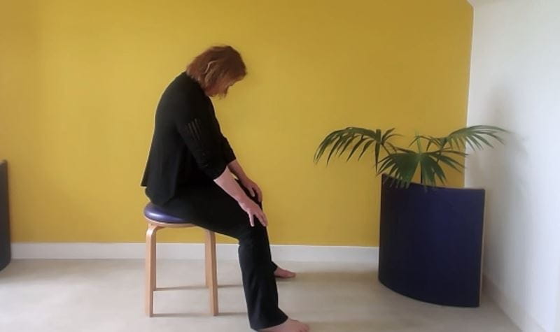 Rolling the head and upper back sat on the chair