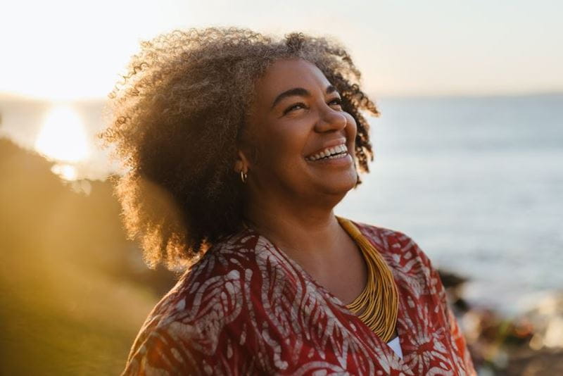Woman looking really happy in the sunset
