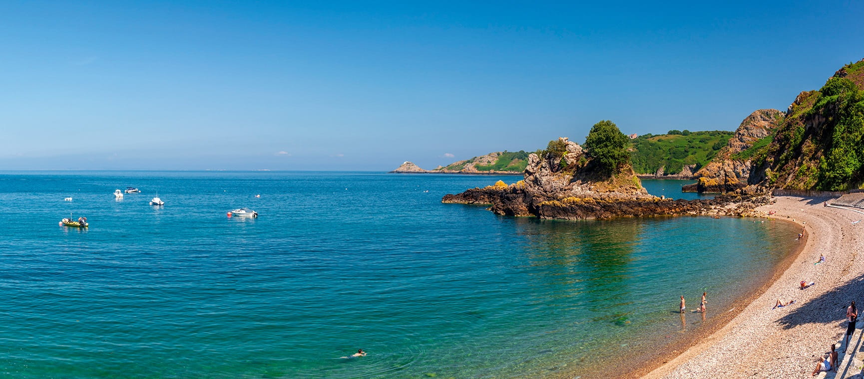 a view of a sandy beach in Jersey with blue skies