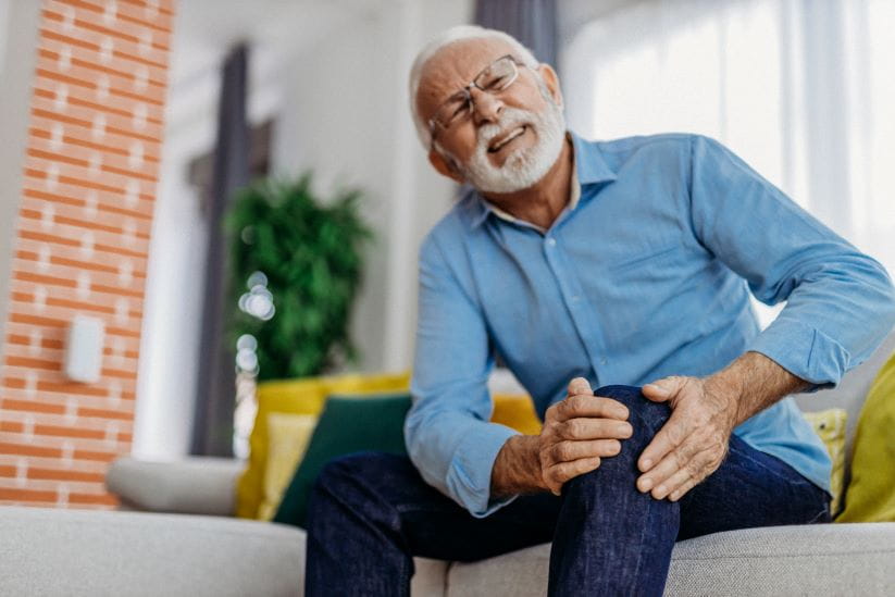 Man holding his knee in pain