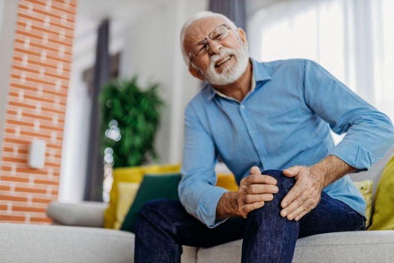 Man holding his knee in pain