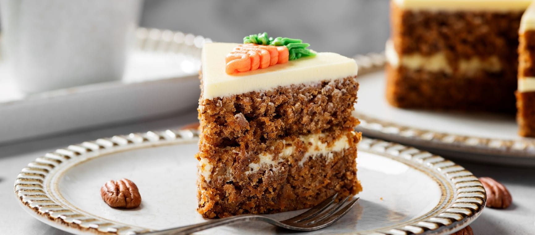 Carrot cake on a plate about to be eaten