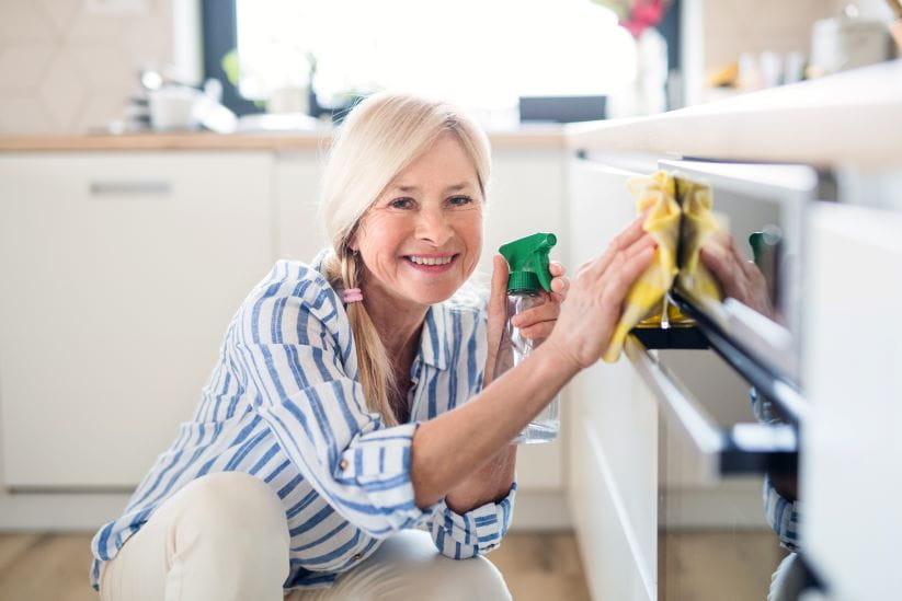 Woman cleaning the oven