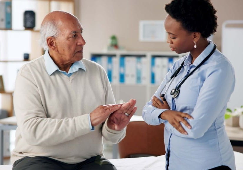 An older man getting advice from a doctor