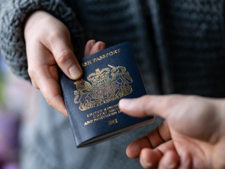 passport being passed from one person to another