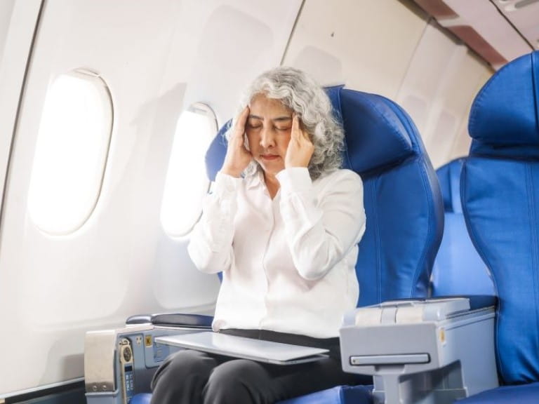 Woman holding her head and breathing deep