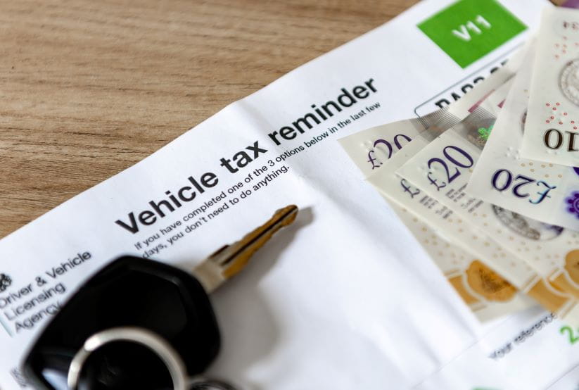 vehicle tax reminder with some money and keys