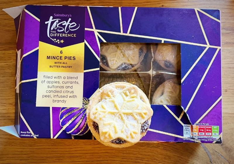 A box of Sainsburys luxury mince pies on a wooden table