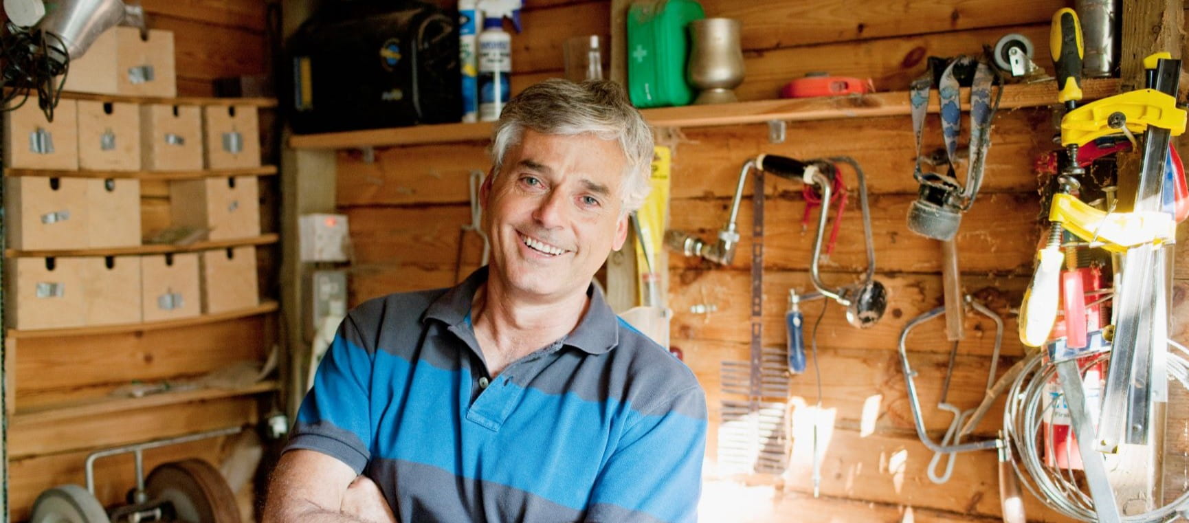 Man standing in his tidy shed
