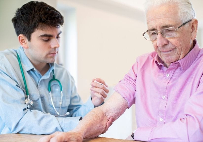 A man receiving an injection from a doctor