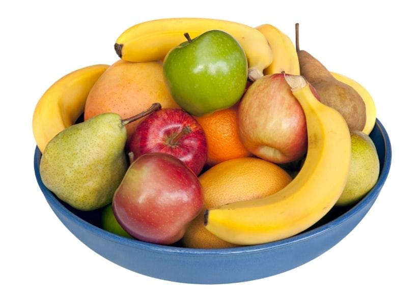 A blue bowl containing fruit including bananas, apples, pears and oranges