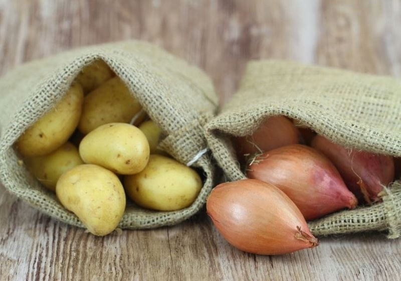 potatoes and onions being stored in separate hessian sacks