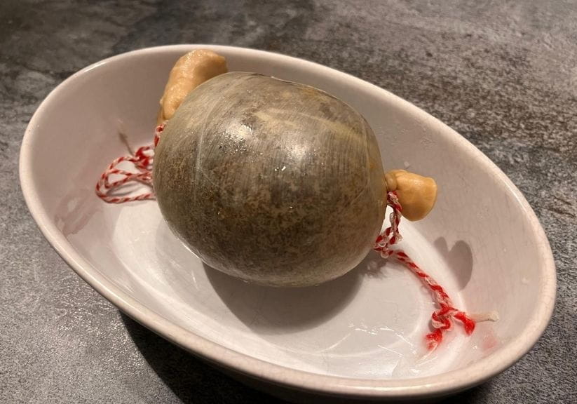 A cooked haggis on a white dish
