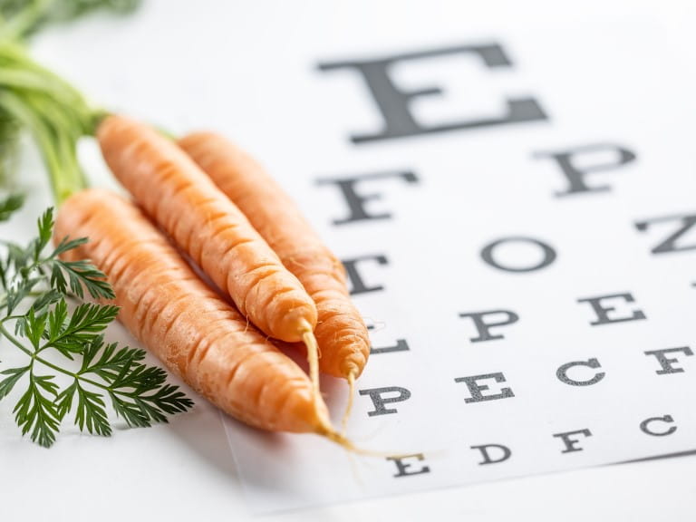 Some carrots next to an eye chart