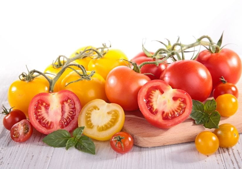 Red and yellow tomatoes on a chopping board