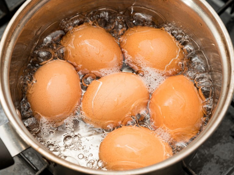 Eggs being boiled in a pan