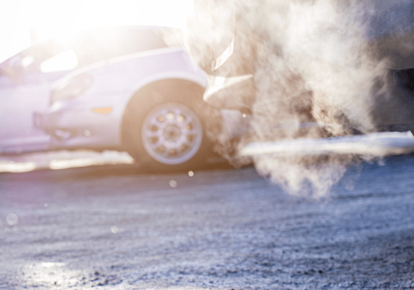The smoke from a car engine running on a cold morning