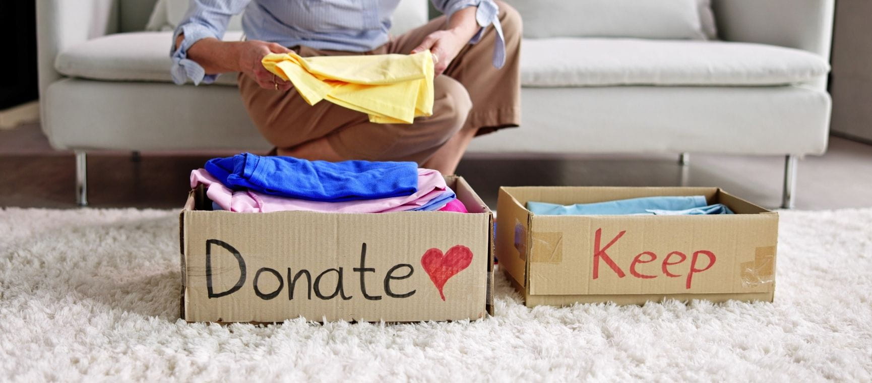 two cardboard boxes with donate and keep written on them