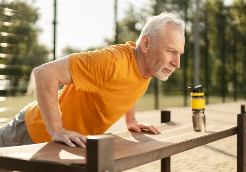 A man doing a push up on a incline