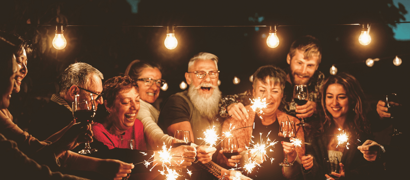 a group of people celebrating with sparklers