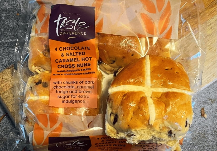 A packet of Sainsburys chocolate and salted caramel hot cross buns
