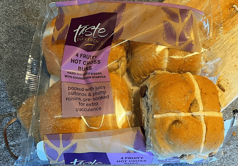 A packet of Sainsbury's Taste the Difference hot cross buns