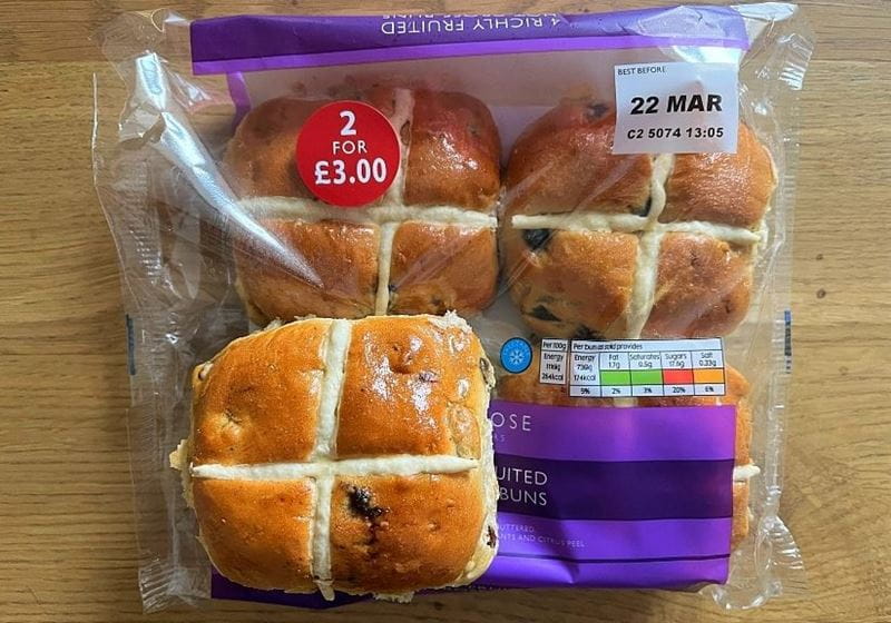 A packet of waitrose richly fruited hot cross buns