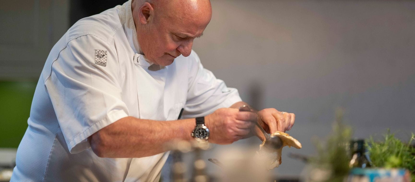 chef Aldo Zilli in his whites preparing food