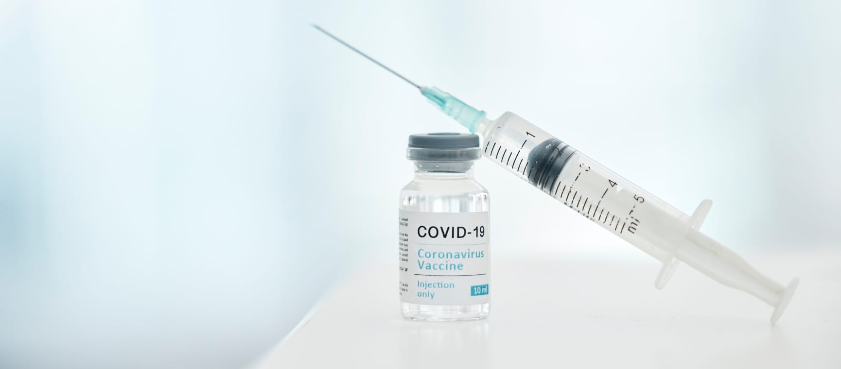 A Covid-19 vaccine and needle