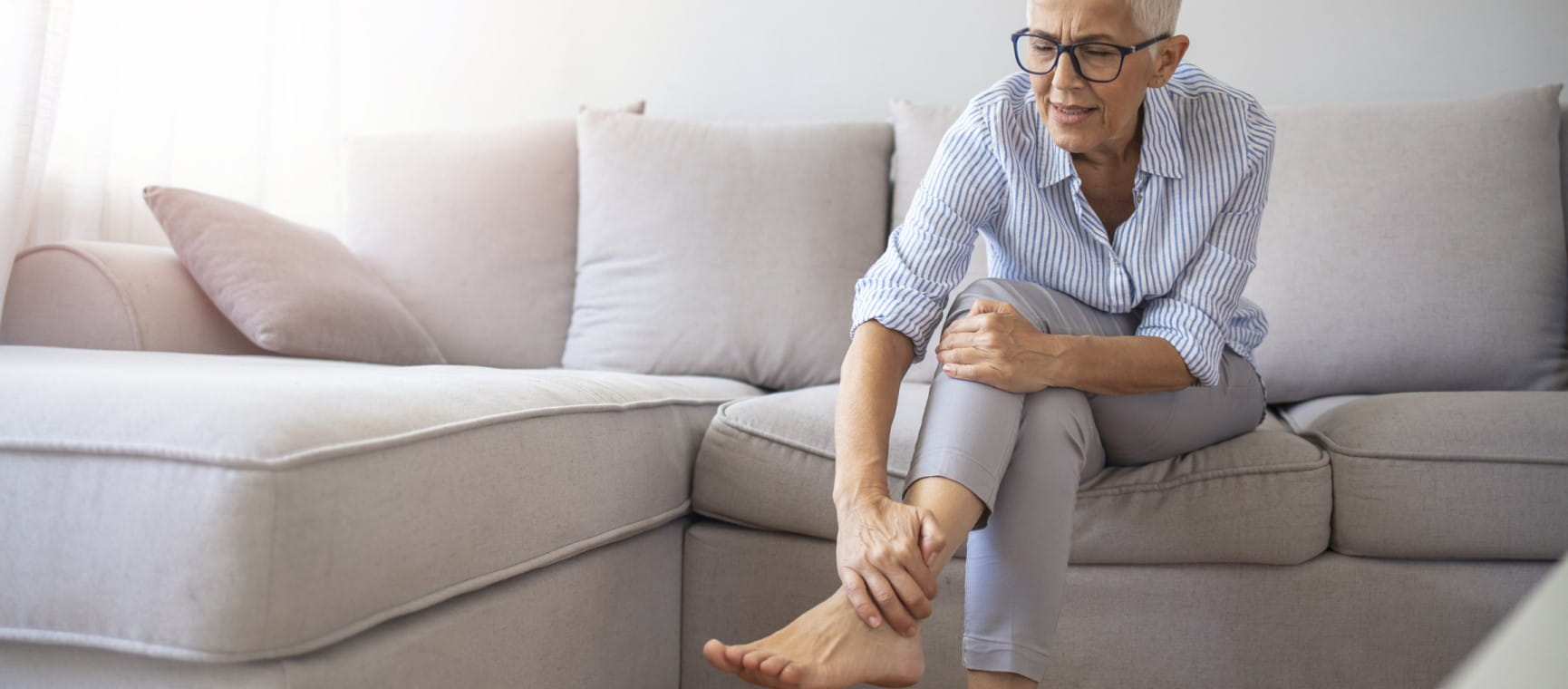 A woman in discomfort rubbing her legs