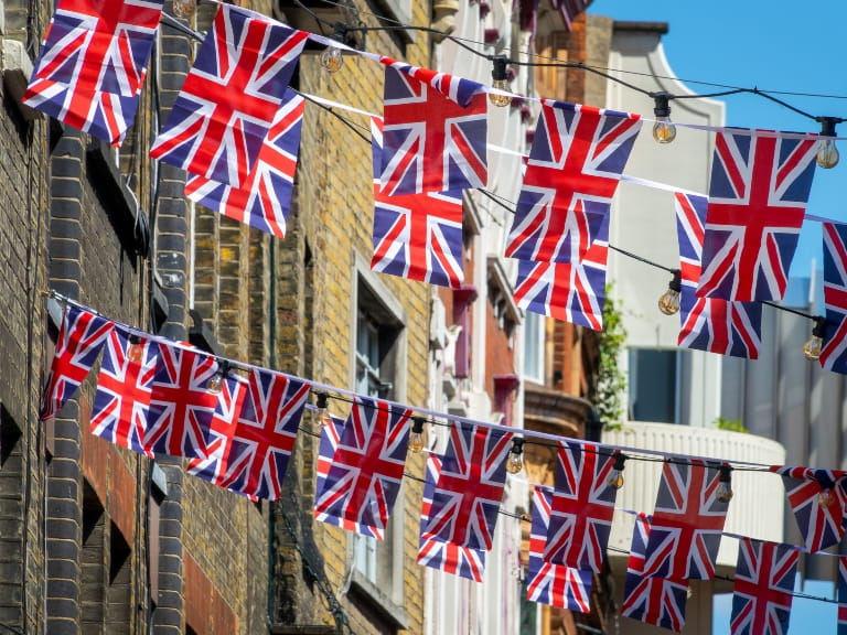 British flag bunting strung between buildings on a London street