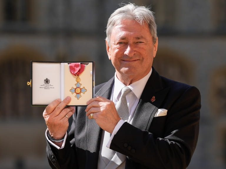 Alan Titchmarsh holding his CBE medal