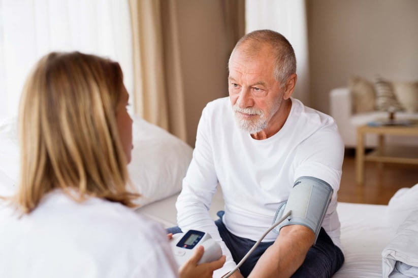 An older man having his blood pressure measured 