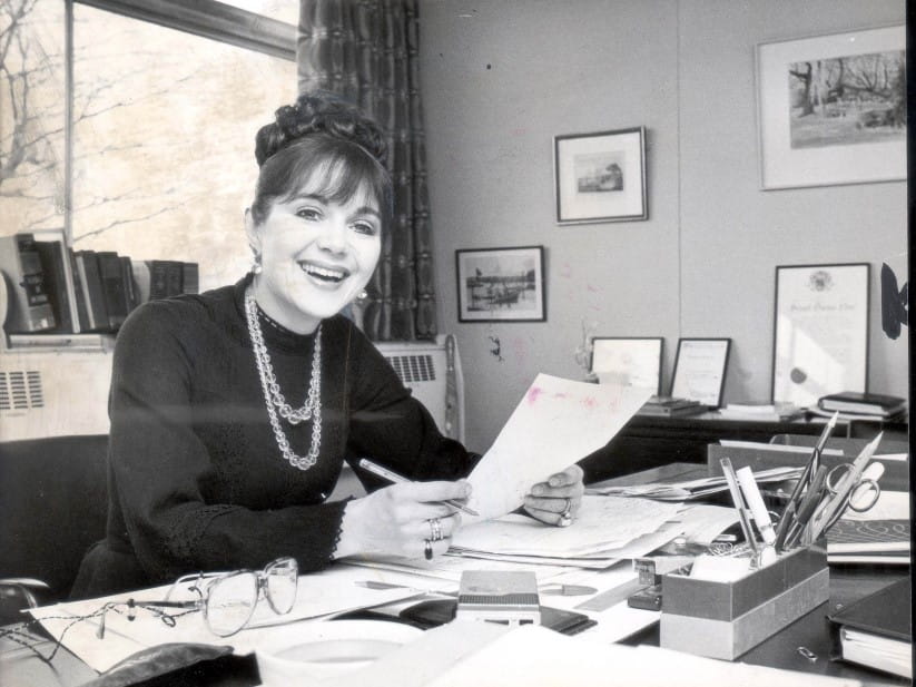 Dr Miriam Stoppard in 1977, sitting at a desk with paper in hand
