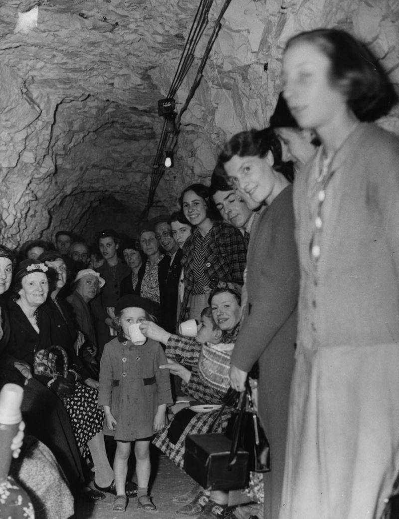 A group of people smiling whilst taking shelter in one of Ramsgate's tunnels