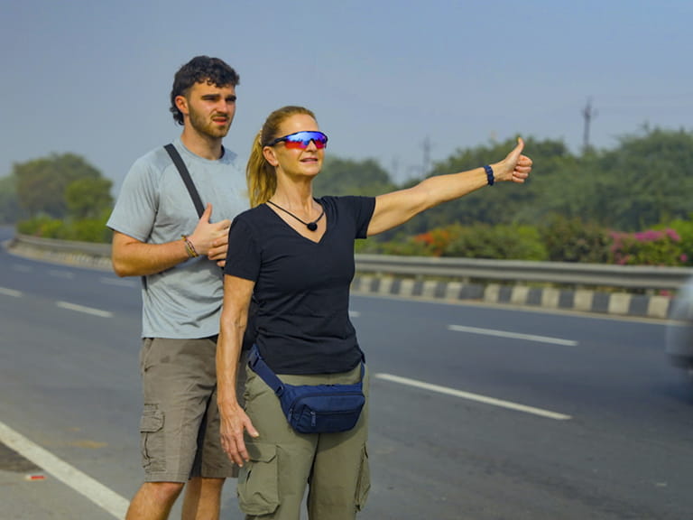 Caroline and Tom hitchhiking in Race Across The World