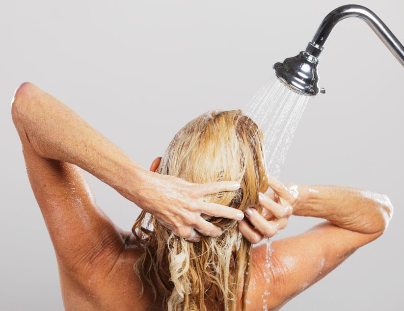 Woman washing her hair in the shower