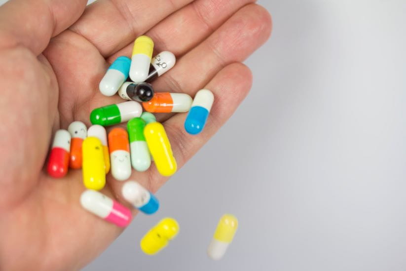 colourful pills being thrown away
