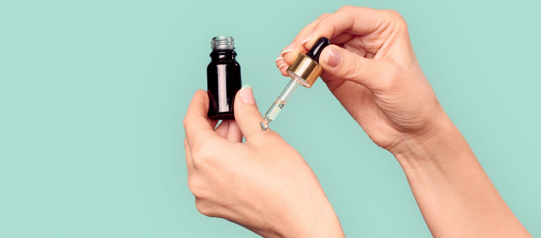 Woman using a pipette on a serum bottle