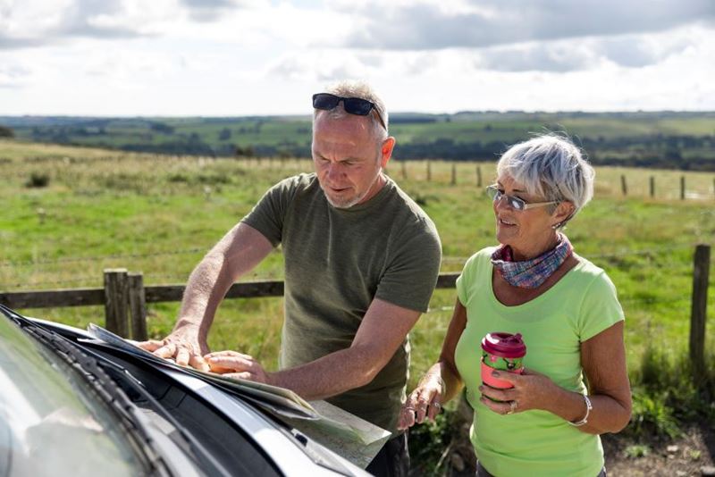A couple checking the map on their road trip